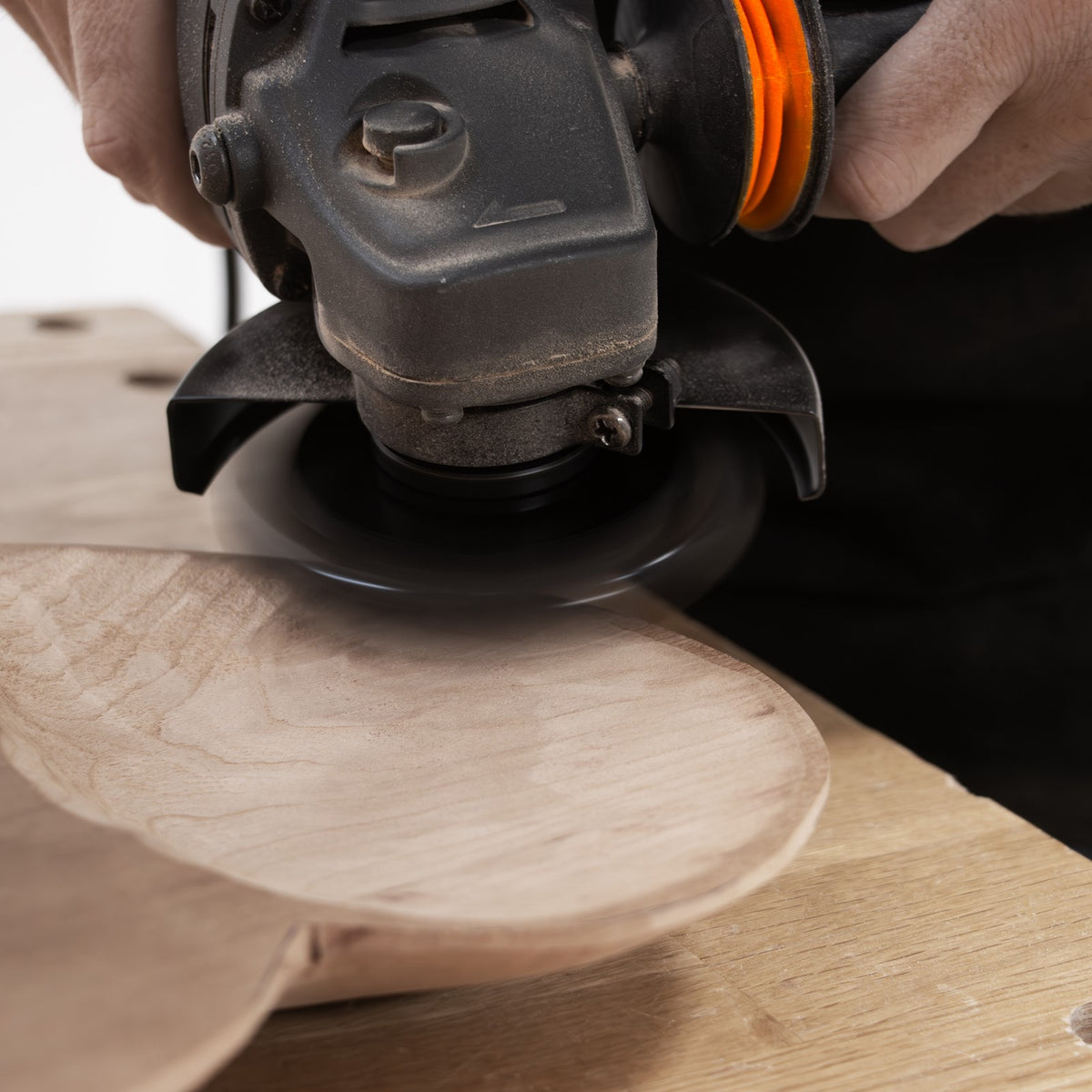 Arbortech Turbo Scraper in action, smoothly carving wood with an angle grinder