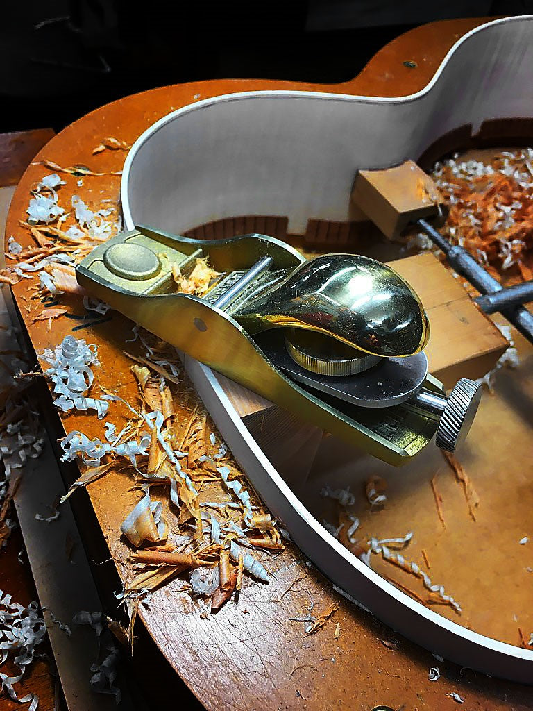 Luban Bronze Knuckle Cap Apron Hand Plane in use on wooden surface, showcasing 20 degree bed angle