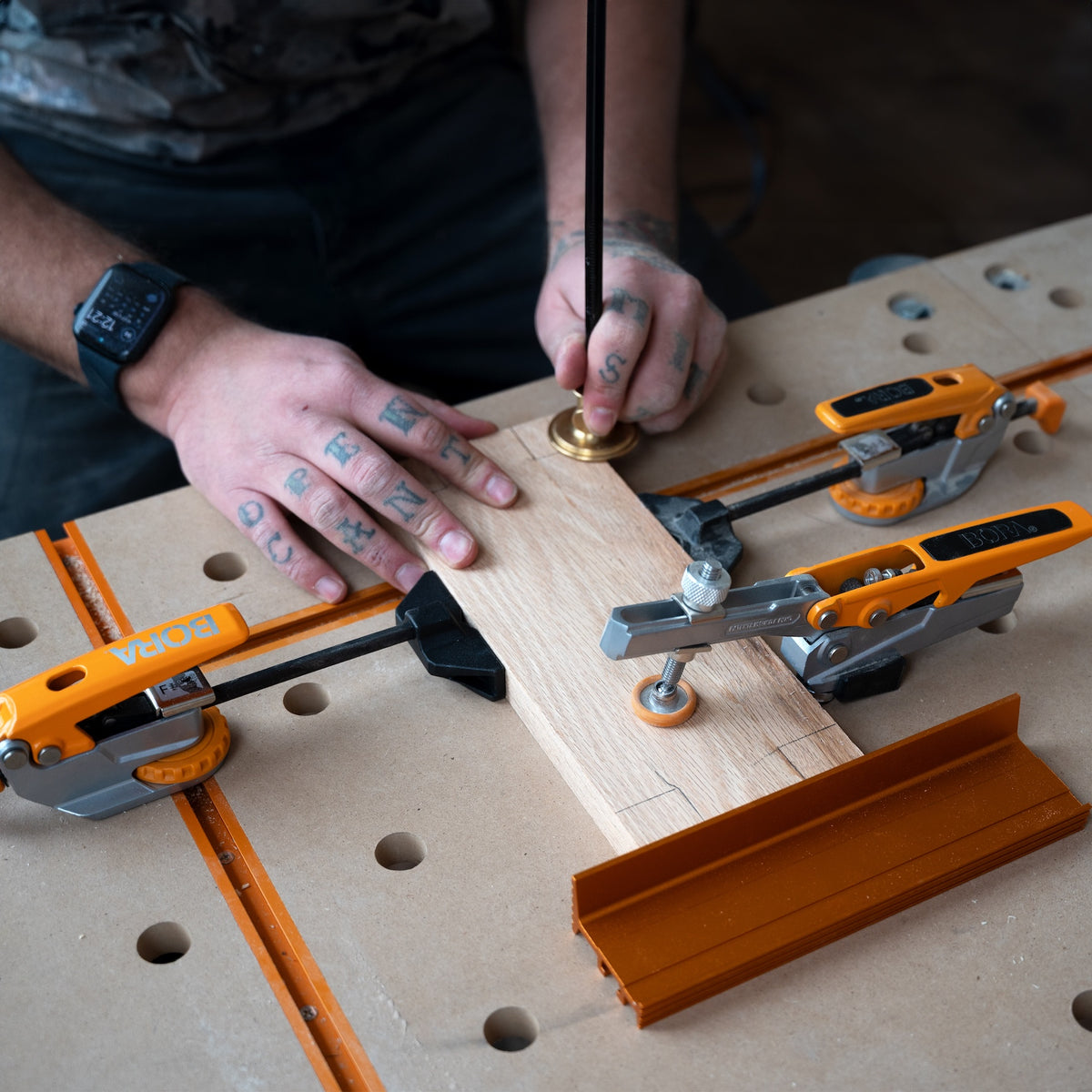 BORA Tool Dog Hole Auto Adjust Inline Toggle Clamp in use on a workbench, showcasing 90mm reach and 360-degree pivot capability