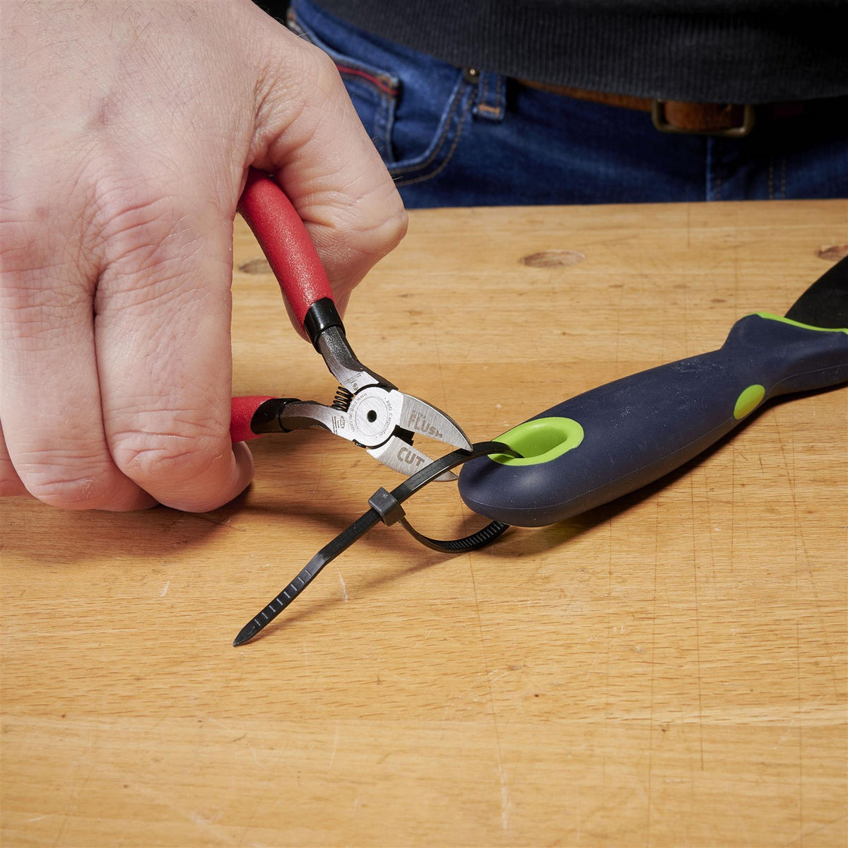 FastCap Micro Flush Cut Trimmers in action, trimming brad nails in tight corners