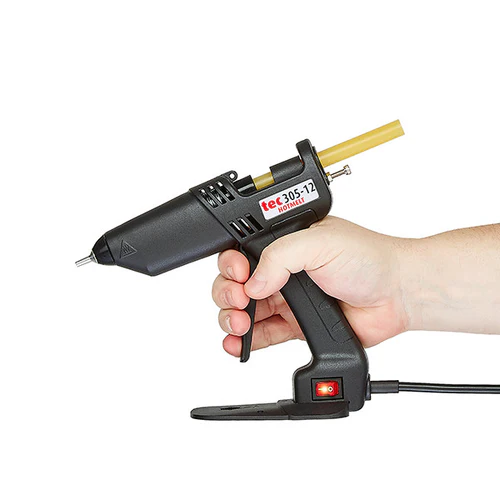 Power Adhesives Knottec Wood Repair Kit hot glue gun applicator in use on a timber surface