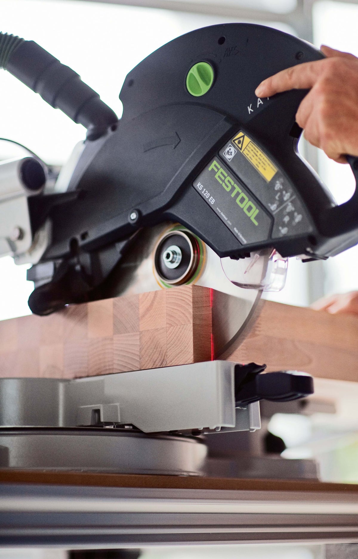 Festool KS 120R Set KAPEX 260mm Slide Compound Mitre Saw in action, cutting skirting board at finished angle with dual line laser beams