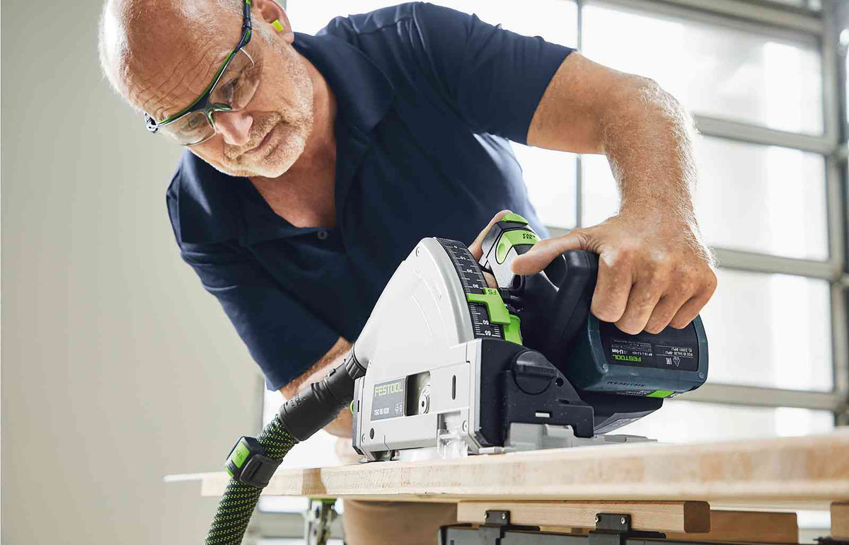 Festool TSC 55K cordless plunge saw cutting through wood with precision