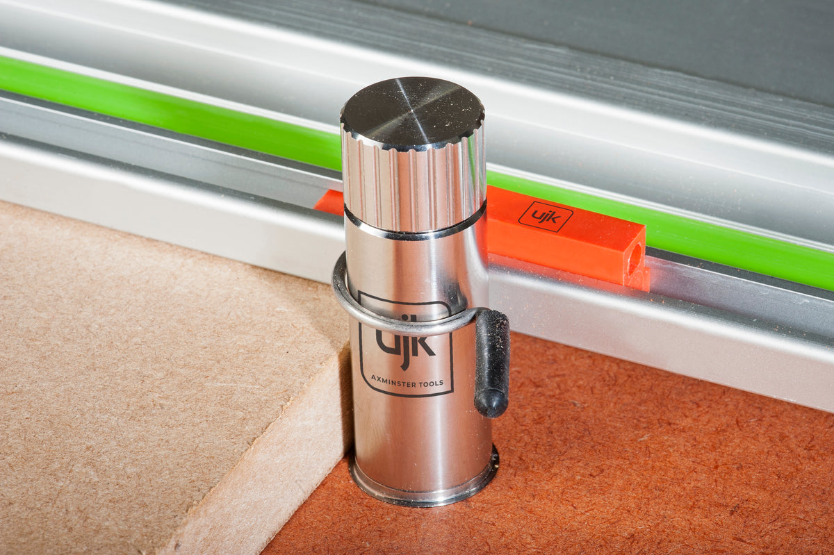 Two UJK Dog Rail Clips securing a guide rail to bench dogs for precise woodworking