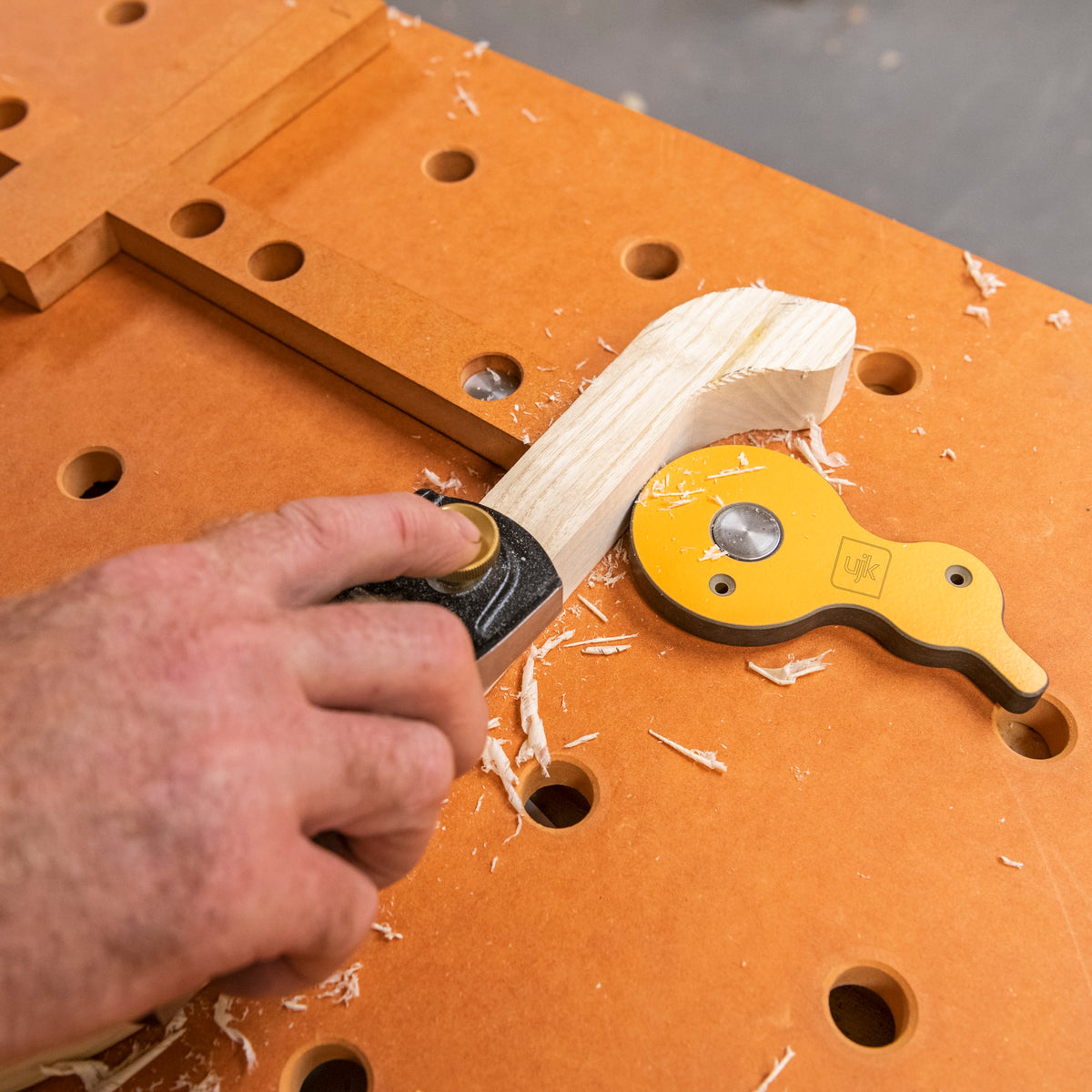 UJK Surface Cam Clamps in action on a woodworking bench with dog hole design
