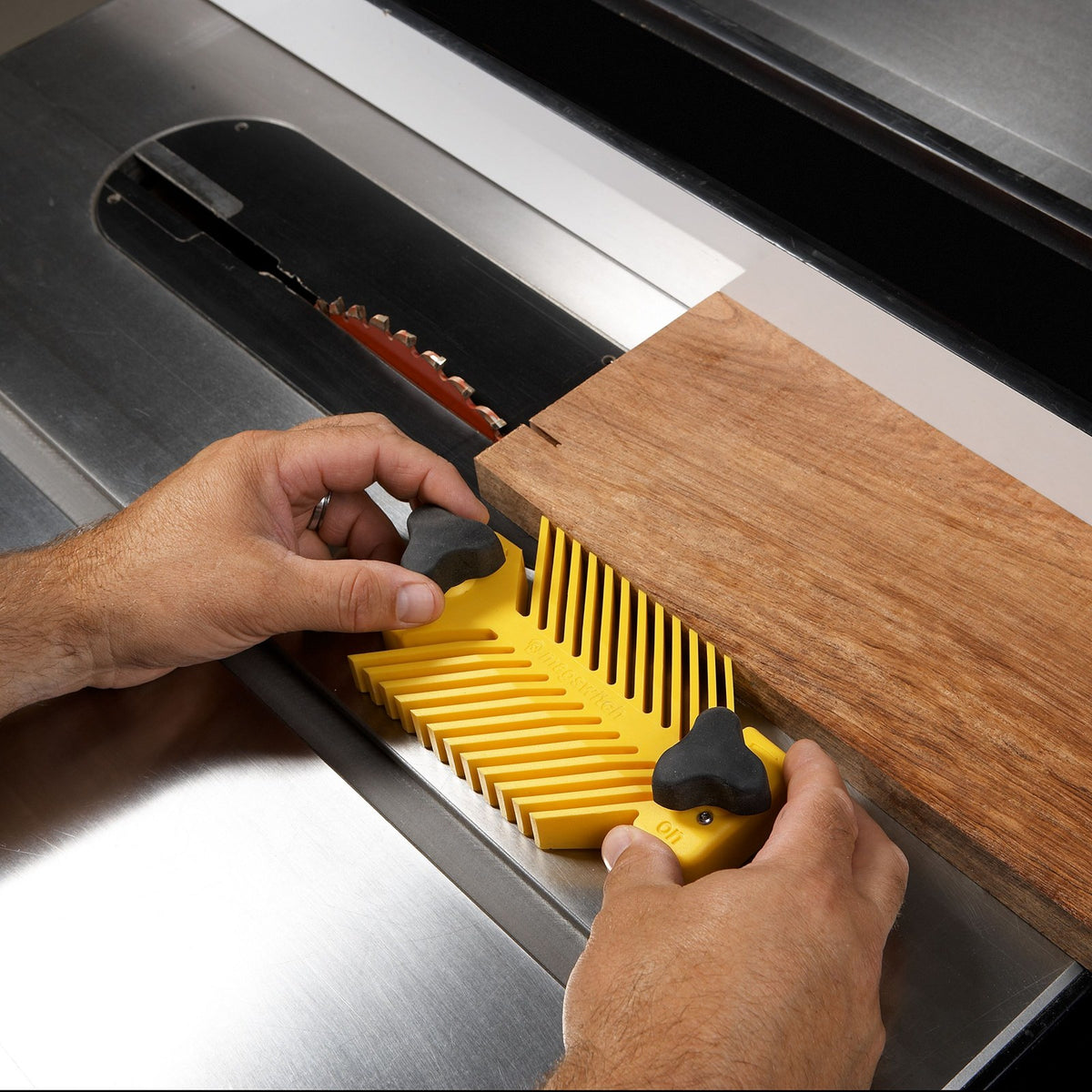 MagSwitch Universal Magnetic Featherboard for Cast Iron Machine Tables in use on a cast-iron fence