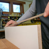 FastCap FastEdge PVC Peel and Stick White Edge Banding roll being applied to a cabinet edge