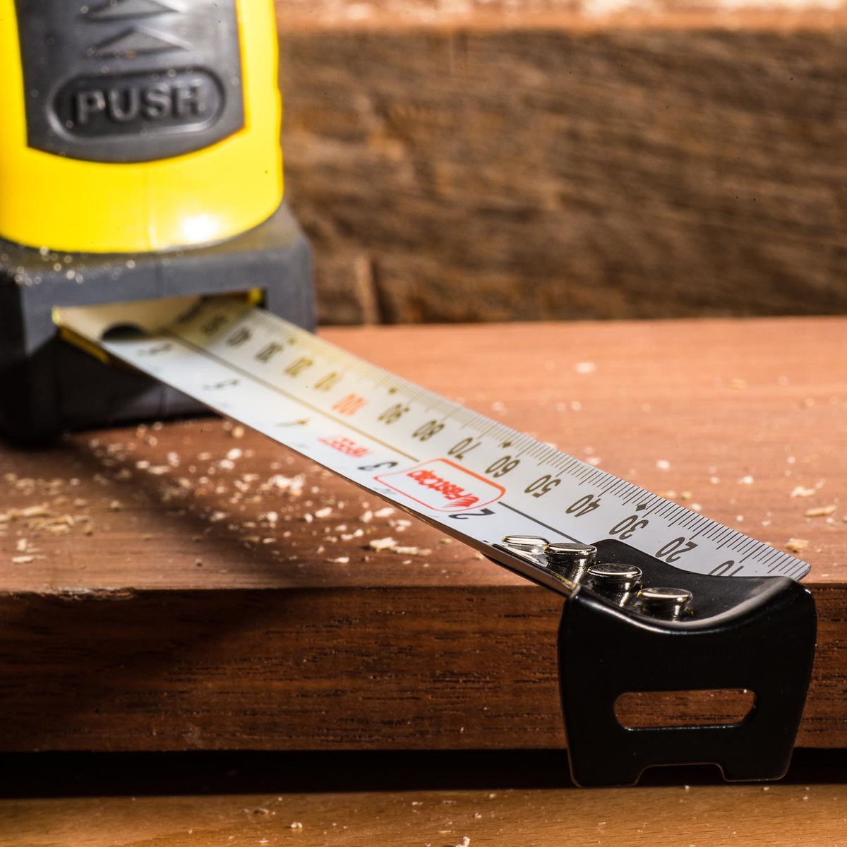 FastCap Auto-Lock Tape Measure with In-Built Pencil Sharpener, showing the retractable feature and metric/imperial tape