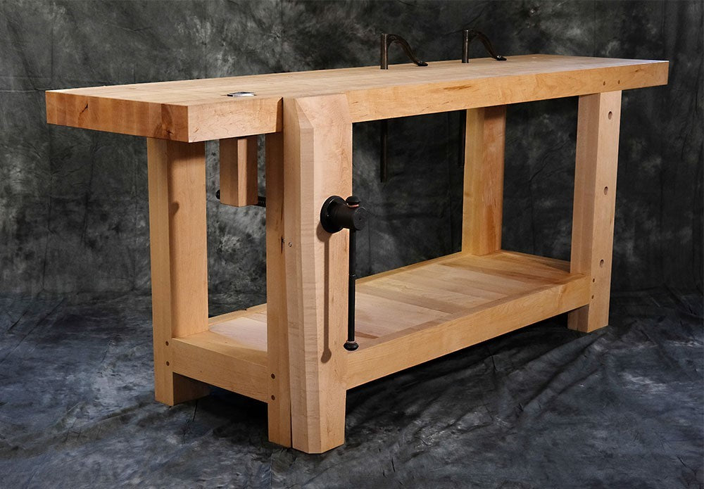 Benchcrafted Cast Iron Hardware Set for Roubo Split Top Bench - Detailed view of hardware set on workbench