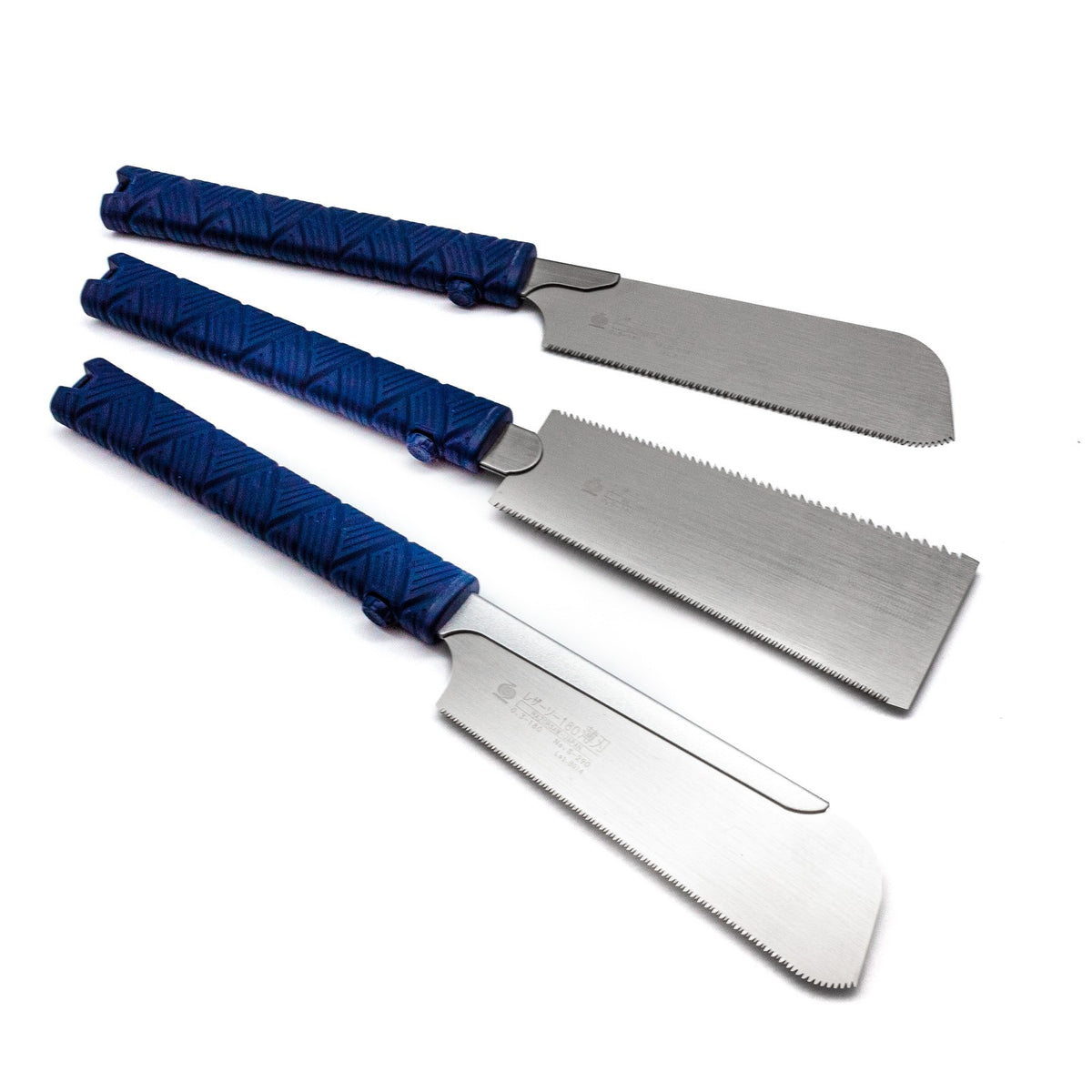 Miniature Japanese saw set with Dozuki, Kataba, and Ryoba saws in a wooden workshop setting