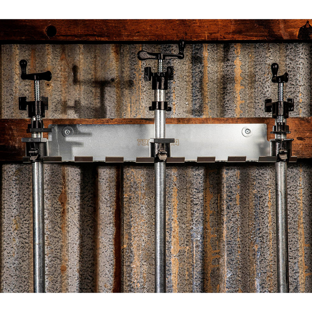 Torquata Steel Clamp Rack holding 9 pipe clamps mounted on wall