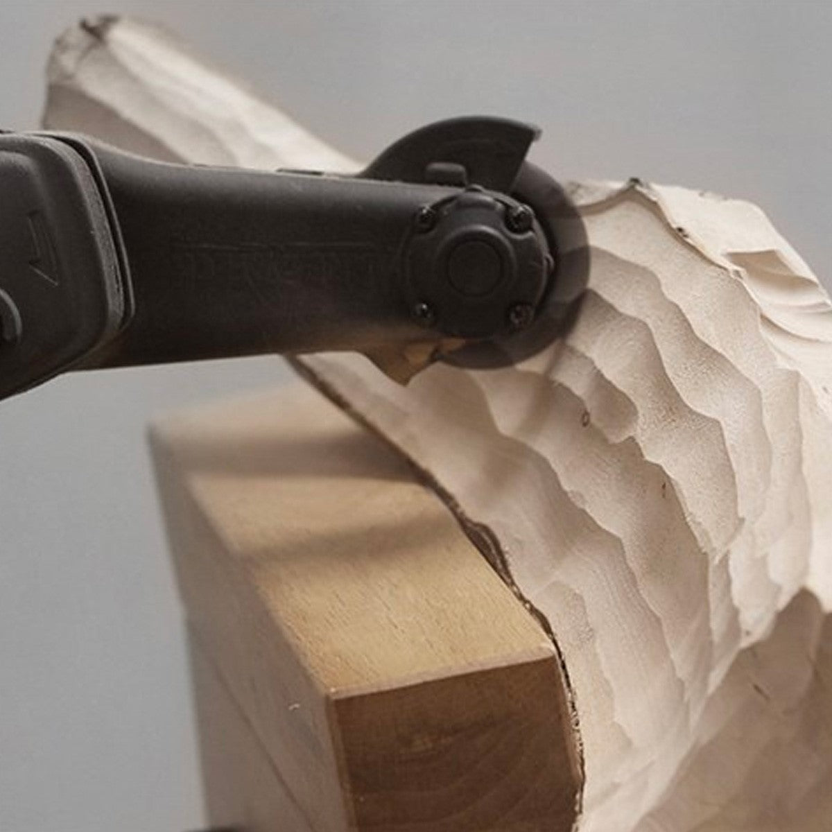 Arbortech Mini Carver 50mm Angle Grinder for wood carving, showcasing its powerful motor and durable Optibelt