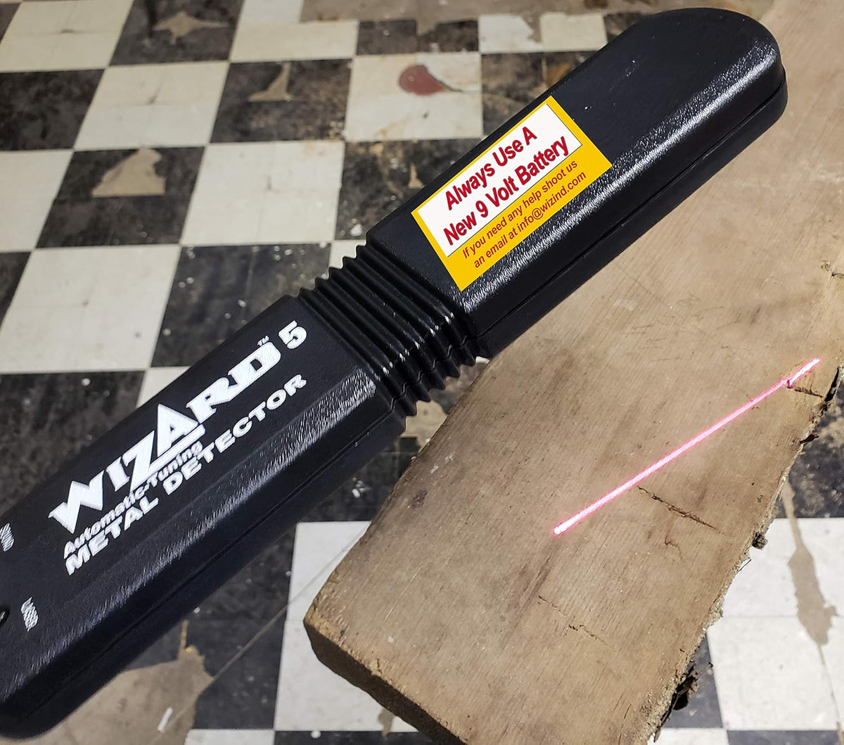 Handheld Lumber Wizard 5 Laser Line Metal Detector in action, protecting woodworkers from hidden metal fragments
