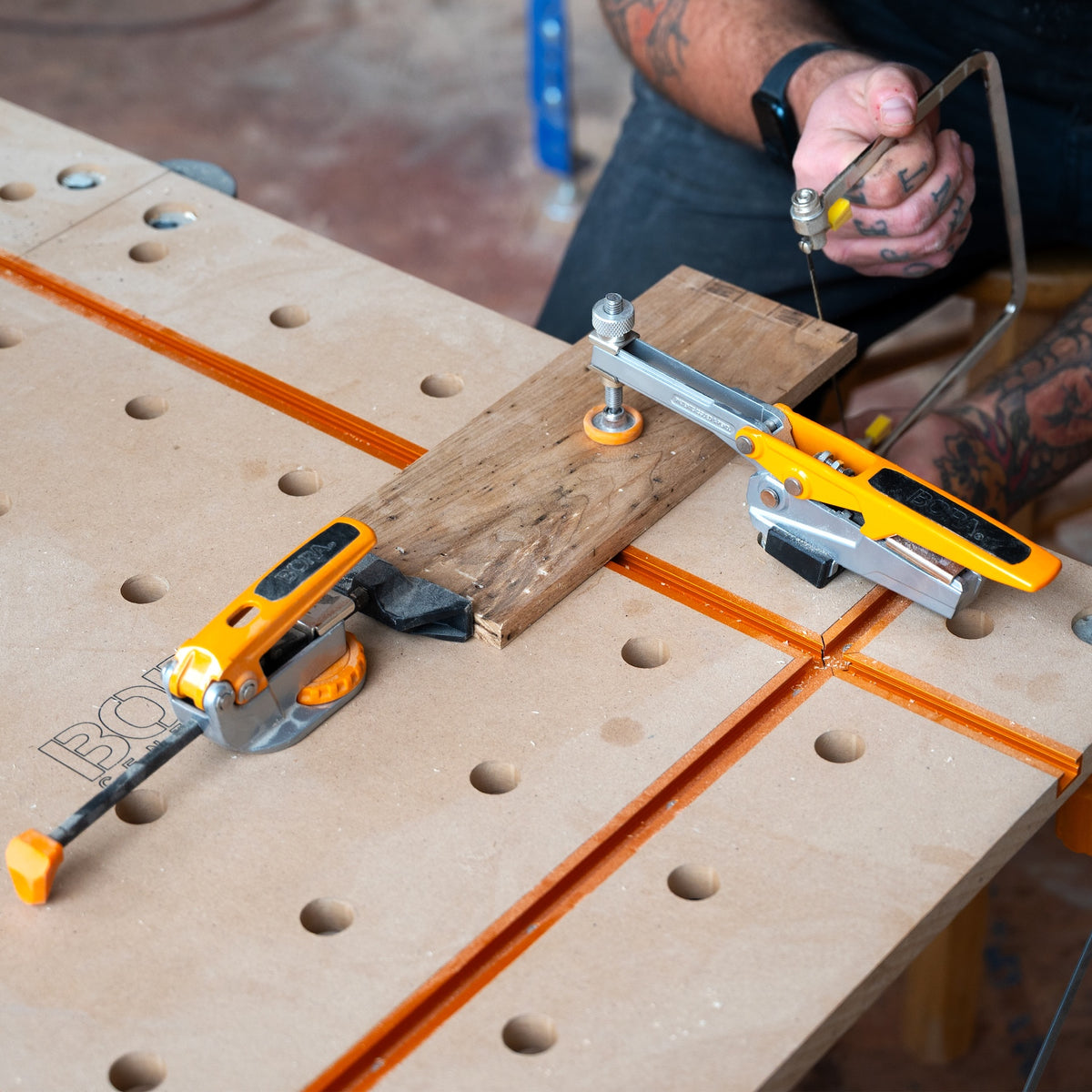 Toggle clamp with serrated bench dog post securely gripping into dog hole, allowing 360° placement