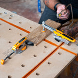 Toggle clamp with serrated bench dog post securely gripping into dog hole, allowing 360° placement