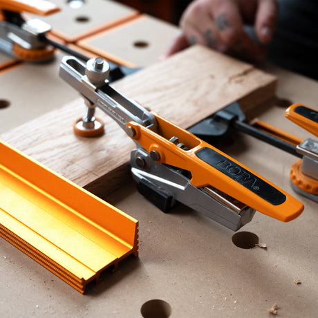 Toggle Clamp with 19mm Bench Dog Post securely gripping into dog hole, providing 360° clamping radius