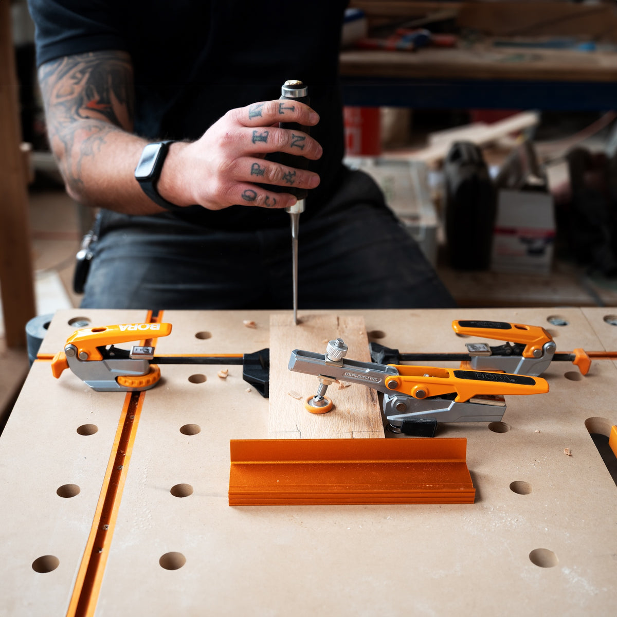 Toggle clamp with 19mm serrated bench dog post securely gripping into dog hole, providing 360-degree clamping radius
