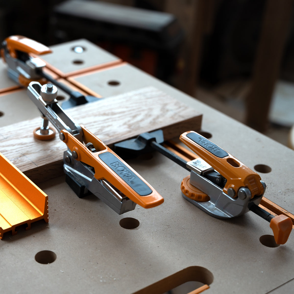 BORA Tool Dog Hole 90mm Inline Toggle Clamp in action on workbench