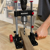Milescraft DrillMatePRO portable drill guide in use on a wooden workpiece