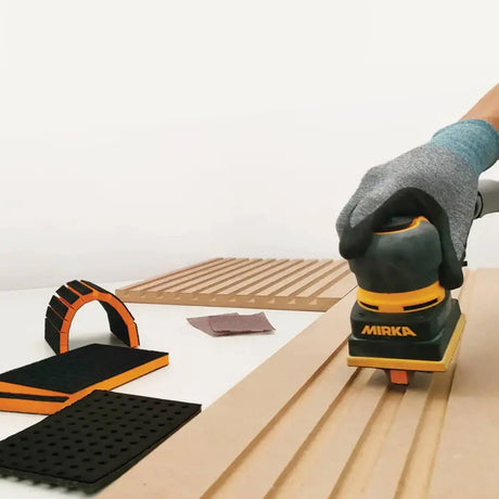Mirka 6 x 12.5mm Soft Groove Interface Grip for DEOS Sanders in use on intricate woodworking surface