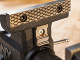 Close-up of a black metal vise with wooden handle