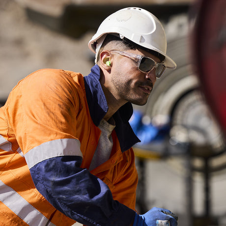 Bollé Safety STKS 420 Smoke Lens Clear Frame safety glasses in action, showcasing stylish design and eco-friendly materials