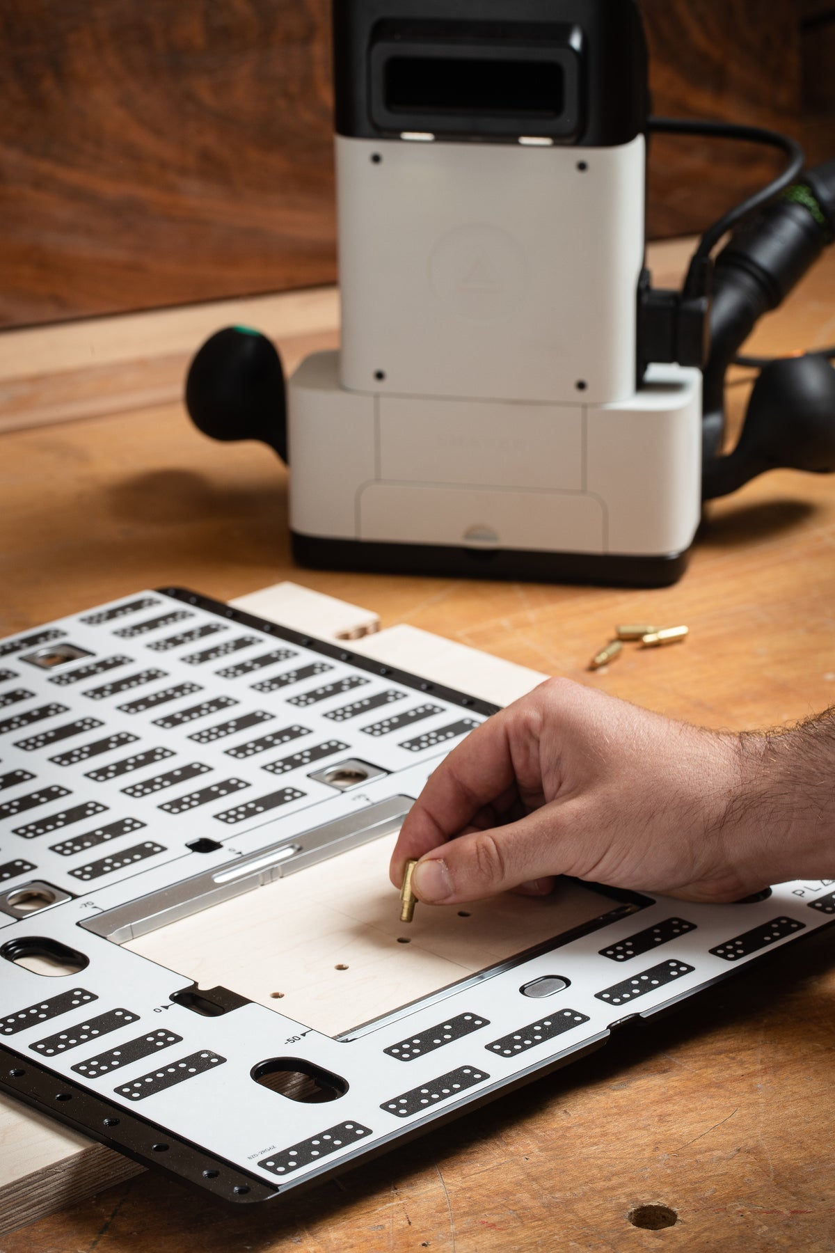 Shaper Tools Origin Handheld CNC Router with Plate Bundle in use on a woodworking project