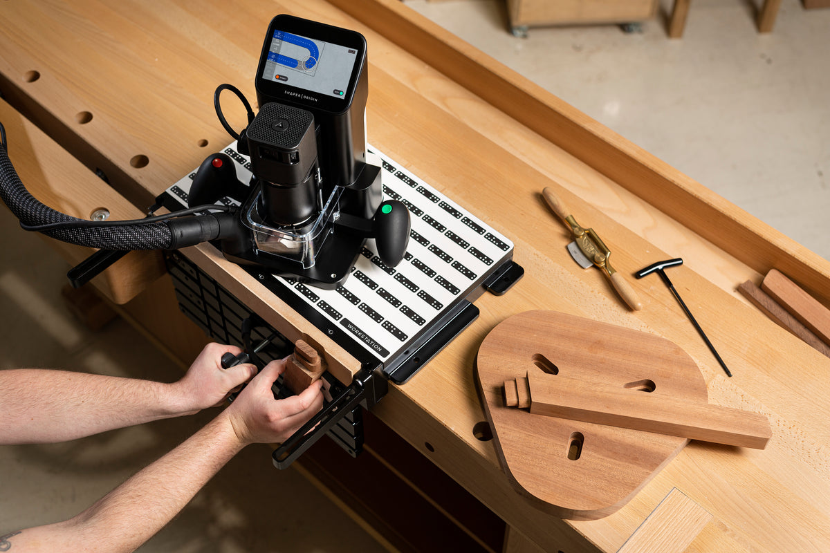 Shaper Origin Handheld CNC Router with Workstation lifestyle shot