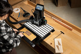 Highly versatile Shaper Workstation for Origin Handheld CNC Router in use on a woodworking bench