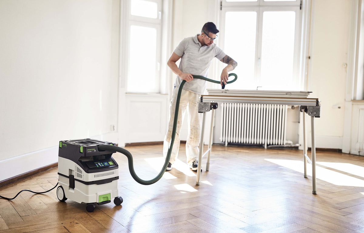 Festool CTM MIDI-I 15L M Class Dust Extractor in use with smooth suction hose and tool storage area