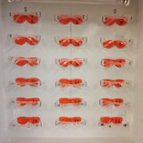 FastCap Eye Mount for CatEyes Safety Glasses being attached to a smooth surface using VHB mounting adhesive